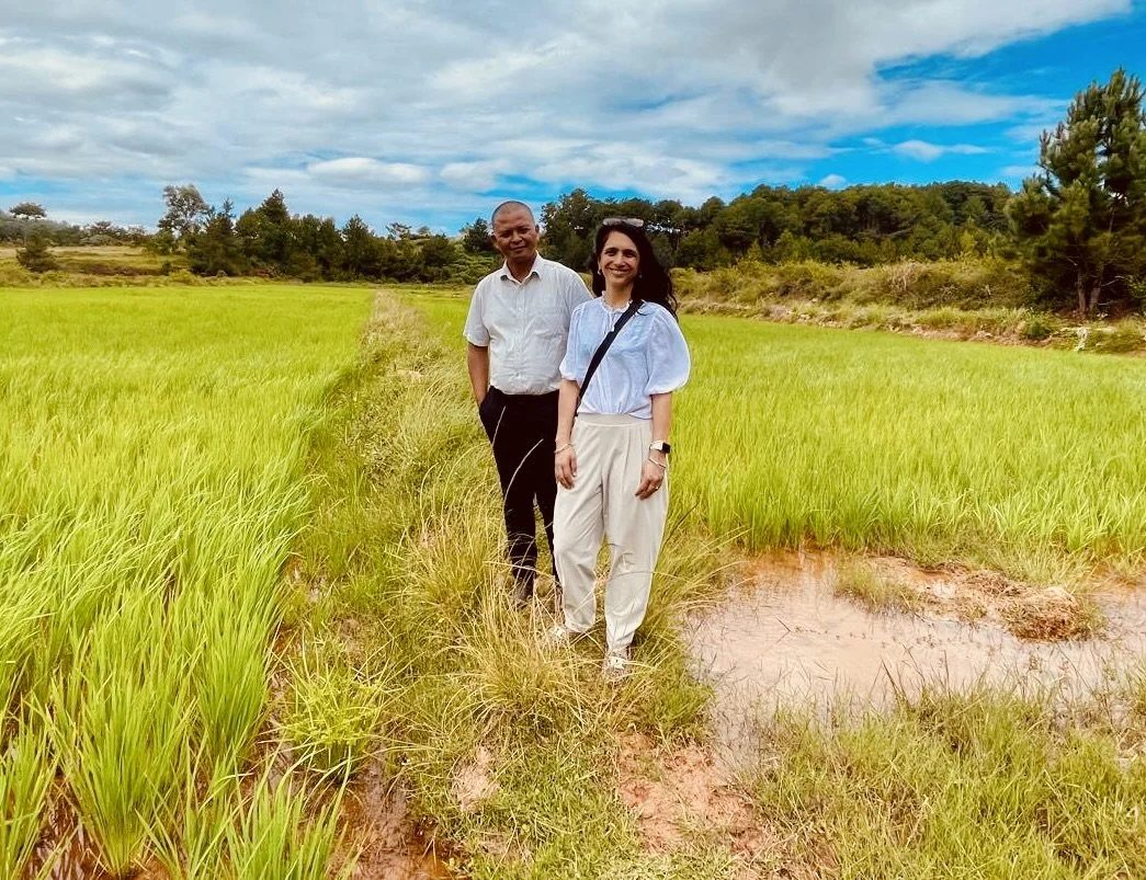 Two members of SRI-2030 standing in a rice field in Madagascar